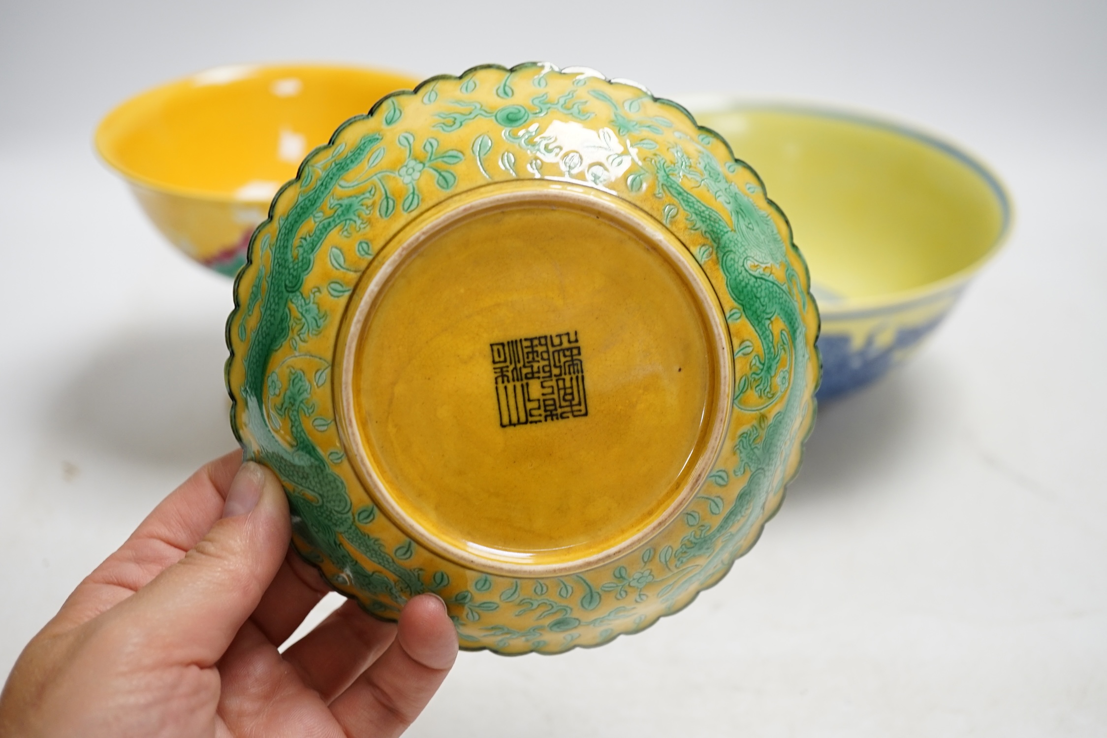A Chinese yellow ground underglaze blue 'dragon' bowl, boxed, a yellow and green 'dragon' dish and a similar stem cup, yellow bowl 19.5cm diameter. Condition - good